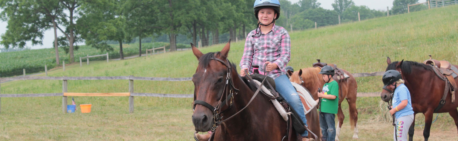 Kids riding horses.